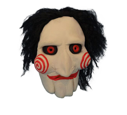 Image is of a latex face mask of the character Saw. Red swirls on cheeks and black hair. Costume shop Sydney