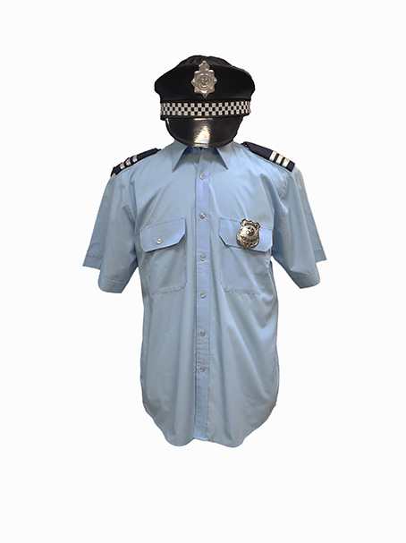 Image is of a blue uniform shirt with epaulets & Police badge, shown on a dress form with a Police hat. Perfect if you are looking for Police uniforms.